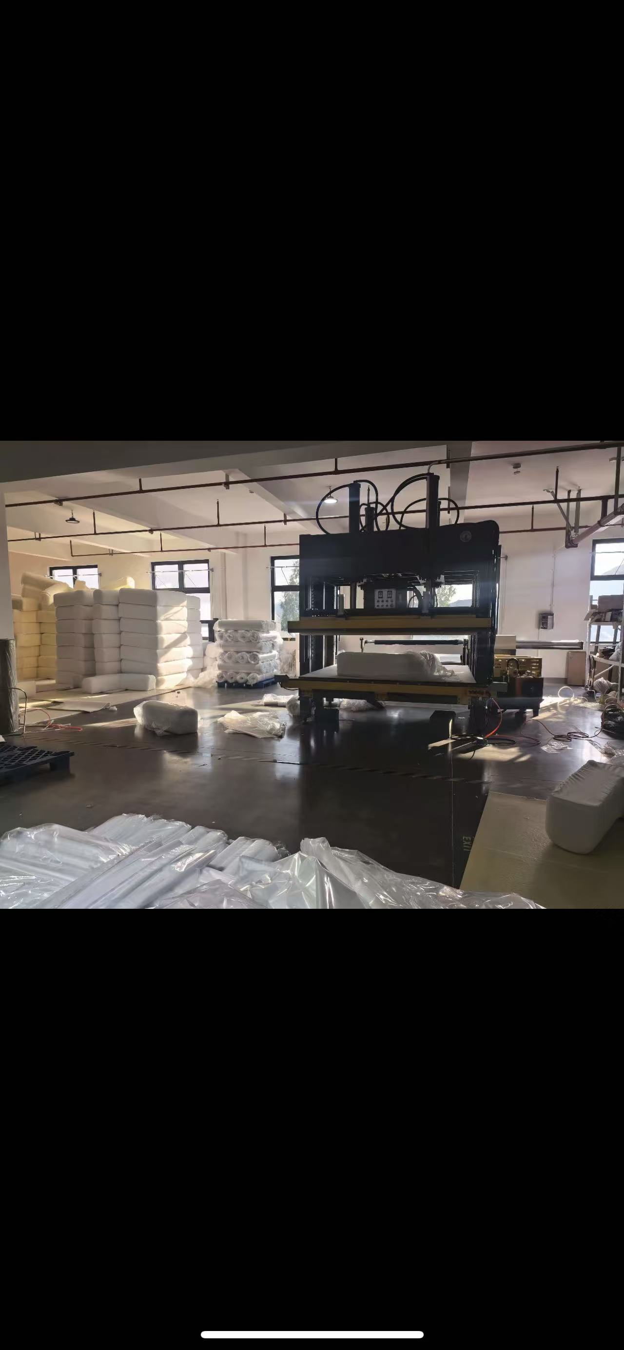 LUVIVO workshop with large-item compression equipment and packed soft furnishings